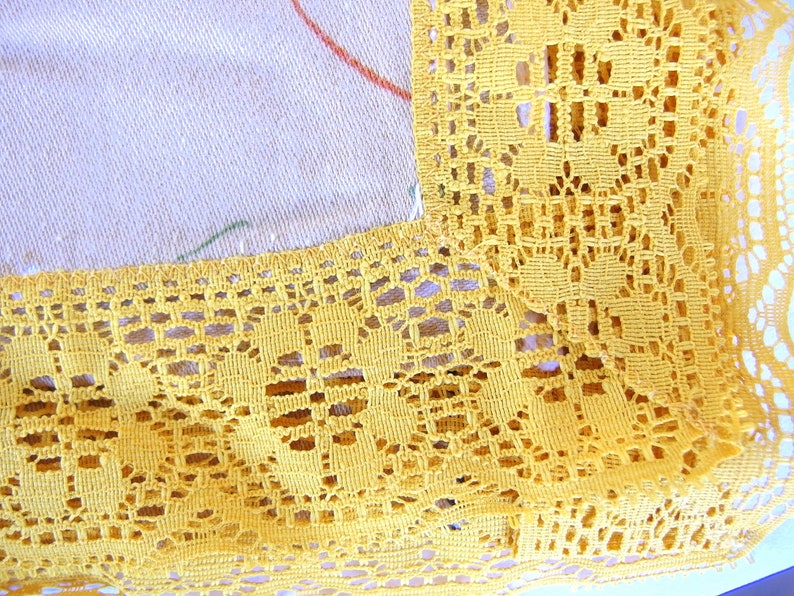 May include: Yellow crochet lace trim with a delicate floral pattern. The lace is made of a fine thread and has a soft, airy feel.