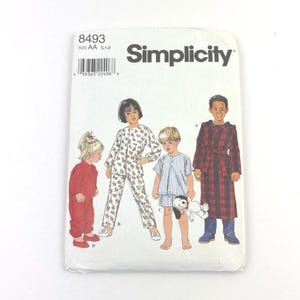 May include: Simplicity sewing pattern for children's sleepwear. The pattern features illustrations of children in various pajamas and a robe. The pattern envelope is white with the Simplicity logo and product details.