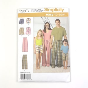 May include: Simplicity sewing pattern 1520A, featuring pajama designs for the family. The pattern includes shorts, pants, and a variety of prints. The packaging shows a family wearing the pajamas. The text "easy-to-sew" is visible.