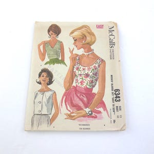 May include: Vintage McCall's printed sewing pattern for a misses' blouse set. The illustration shows three blouse designs with a retro aesthetic. The pattern is marked "Easy to Sew" and "Recommended for Beginners". The bust size is 32 inches.