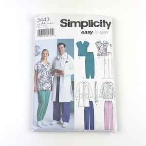 May include: Simplicity sewing pattern 5443 for medical scrubs and lab coats. The pattern includes illustrations of various scrub tops, pants, and a lab coat. The package features images of people wearing the garments. The text "easy-to-sew" is visible.