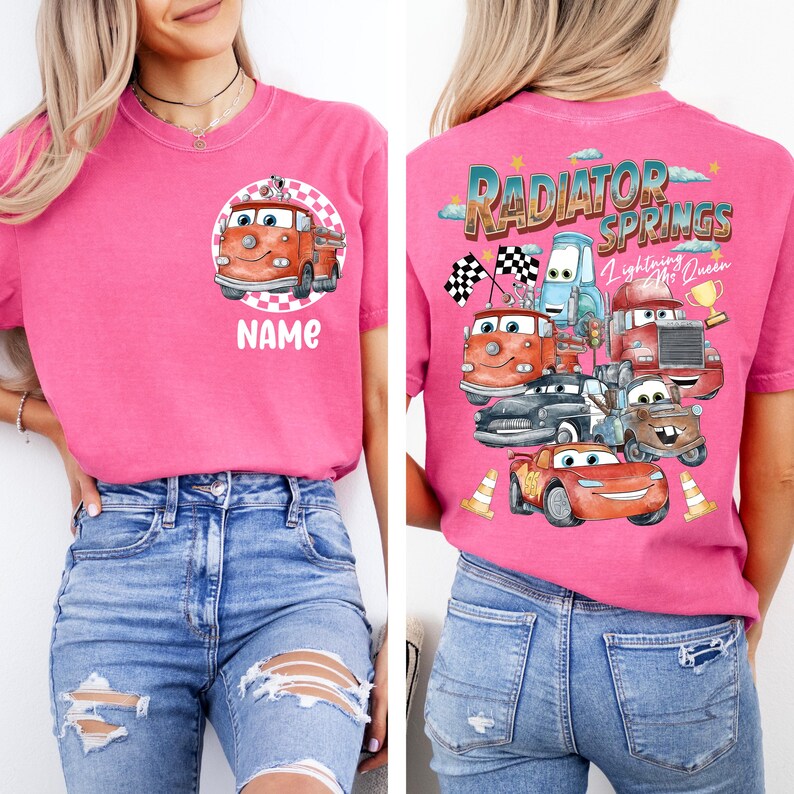 May include: Pink t-shirt featuring a cartoon fire truck design on the front with the word "NAME" below. The back of the shirt displays a "Radiator Springs" graphic with various car characters and the text "Lightning McQueen".