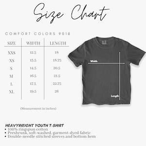 May include: A size chart for a heavyweight youth t-shirt, with measurements in inches. The chart includes sizes XXS to XL, with width and length dimensions. A gray t-shirt is shown with width and length indicators. The shirt is made of 100% ringspun cotton.