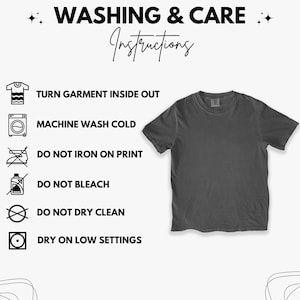 May include: A dark grey crew neck t-shirt with washing instructions. The text reads: Turn garment inside out, machine wash cold, do not iron on print, do not bleach, do not dry clean, and dry on low settings.