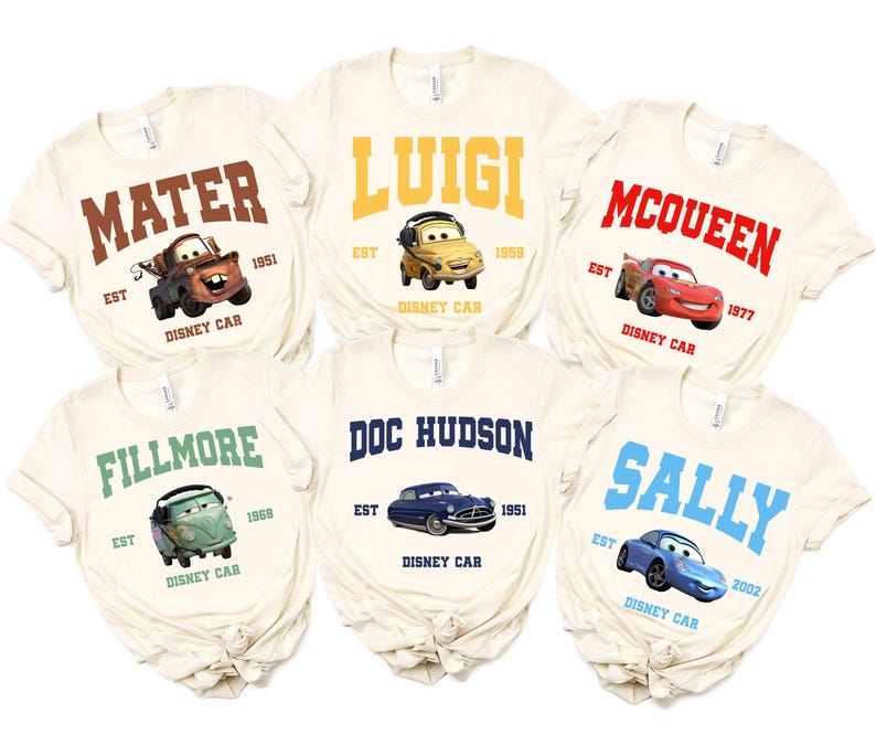 May include: Six off-white t-shirts featuring Disney Cars characters. Each shirt displays a character's name in bold letters, along with an image of the car and the text "Disney Car". The characters include Mater, Luigi, McQueen, Fillmore, Doc Hudson, and Sally.