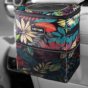 May include: A car trash bin with a colorful floral pattern featuring red, yellow, and teal leaves on a black background. The bin has a mesh pocket and the word "HOTOR" is printed on the front.