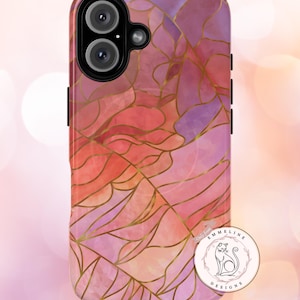 May include: A phone case with a watercolor design in shades of pink, red, and purple, accented with gold lines. The case features a dual-lens camera cutout and black side buttons. A circular logo with a cat illustration is visible.