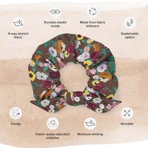May include: A brown scrunchie with a floral print featuring various shades of pink, yellow, and white flowers. The scrunchie is made from fabric leftovers and has a durable elastic inside.