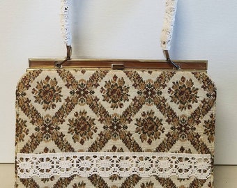 Upcycled vintage brocade snap closure frame bag with lace accents.