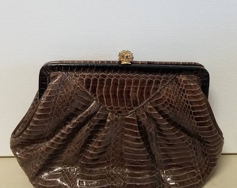 Luxurious brown Lyrella clutch with rhinestone snap clasp.