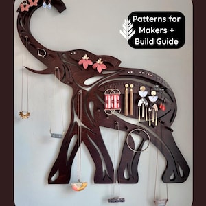 May include: A dark brown wooden wall-mounted jewelry organizer shaped like an elephant with cut-out details. It features multiple hooks and holes for hanging necklaces, earrings, and rings. The text "Patterns for Makers + Build Guide" is visible.