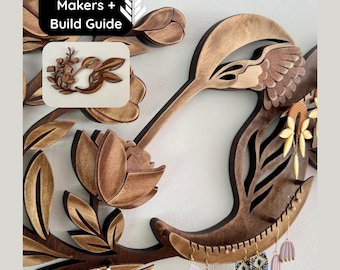 May include: A wall-mounted wooden jewelry organizer featuring a hummingbird and floral design with integrated slots for hanging earrings. The text "Patterns for Makers + Build Guide" is visible in the upper left corner, along with a small inset image.