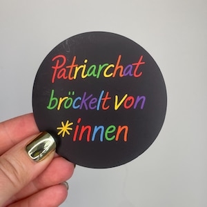 May include: A set of three ceramic mugs with a speckled, matte finish. The mugs are in shades of cream, light gray, and dark gray. Each mug has a simple, minimalist design, perfect for coffee or tea.