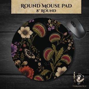May include: Round mouse pad, 8 inches in diameter, featuring a black background with a floral design. The design includes Venus flytraps, flowers, and a butterfly. A black computer mouse is on the right.