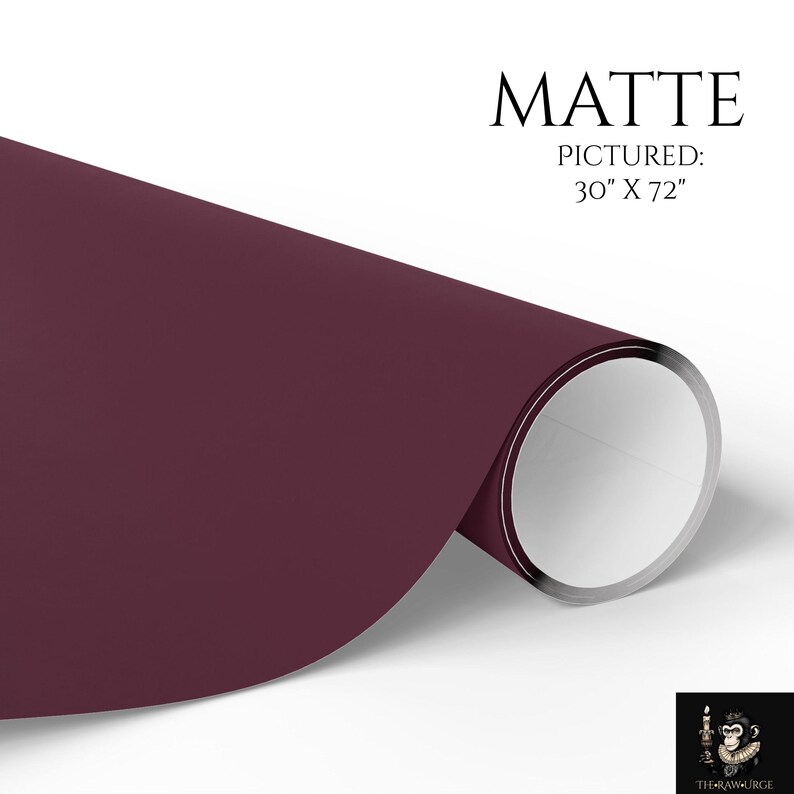 May include: A roll of matte finish dark burgundy paper with a smooth texture. The text MATTE PICTURED: 30" X 72" is printed in black above the roll. A small logo featuring a monkey holding a candle is visible in the bottom right corner.
