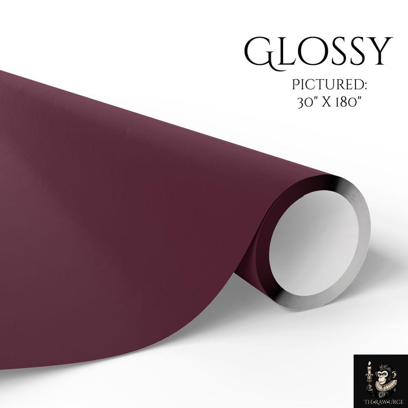 May include: A roll of deep burgundy glossy paper with a smooth finish. The text GLOSSY and PICTURED: 30" X 180" is printed in black above the roll. A small logo featuring a monkey holding a candle is visible in the bottom right corner.