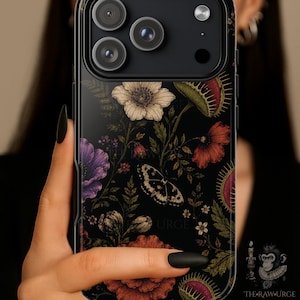 May include: Black phone case featuring a floral and butterfly design. The case has a dark background with colorful flowers, a butterfly, and the text "URGE". The case is designed for a smartphone.