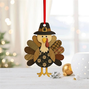 May include: Wooden Thanksgiving turkey ornament with a black pilgrim hat and a red ribbon for hanging. The turkey has patterned feathers in shades of brown, tan, and green, and a black dress with white flowers. A festive decoration.