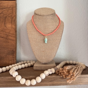 The Lure Necklace – Coral Glass Bead Necklace with Teal Fish Charm | Handmade Summer Jewelry | Boho Beach Necklace | Fun Gift for Her