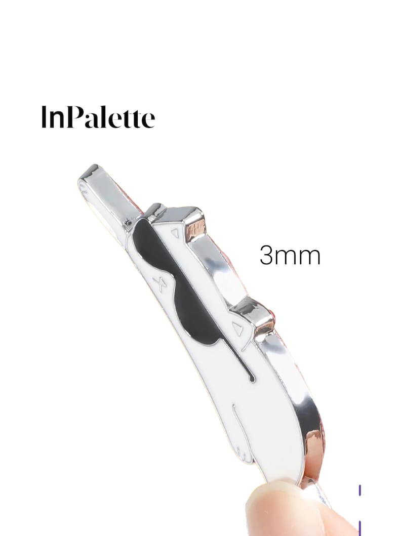 May include: A silver and white cat-shaped pin with black detailing. The pin is 3mm thick and features the text "InPalette". The pin has a shiny finish and a simple design.