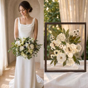 May include: A white sleeveless gown with a square neckline and a bouquet of white flowers and greenery. Beside it, a dark wooden frame contains a pressed floral arrangement featuring white blossoms, ferns, and leaves on a clear glass background.