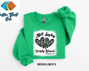 May include: A green sweatshirt with a white graphic that says "Not Lucky Simply Blessed Romans 4:7-8" with a black and green shamrock and two leopard print hearts.