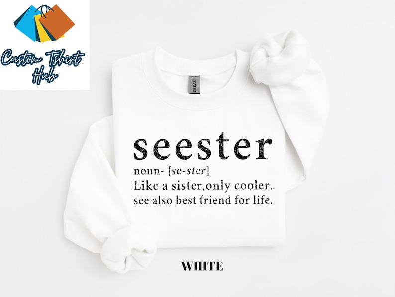 May include: White t-shirt with black text that reads "seester" defined as "noun- [se-ster] Like a sister, only cooler. see also best friend for life."