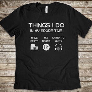 May include: Black t-shirt with white text that reads "Things I do in my spare time".  The text is divided into three sections: "Make Beats", "Mix Beats", and "Listen to Beats". Each section has a graphic icon representing the activity.