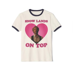 Snow lands on top Coriolanus Snow in Blond Shirt, Tom Blyth ringer T-shirt, Coriolanus Snow Tee, Tom Blyth t-shirts