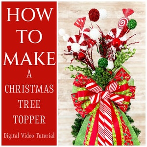 May include: How to Make a Christmas Tree Topper - Digital Video Tutorial. A red, white, and green Christmas tree topper with a large bow, candy canes, and other festive decorations.