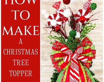 May include: How to Make a Christmas Tree Topper - Digital Video Tutorial. A red, white, and green Christmas tree topper with a large bow, candy canes, and other festive decorations.