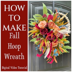 May include: A colourful fall hoop wreath with a floral arrangement. The wreath includes peach and burgundy roses, complemented by orange, yellow, and blue accents. A red ribbon adds a touch of elegance. The text "HOW TO MAKE Fall Hoop Wreath" is visible.