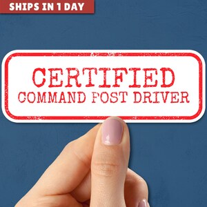 May include: White sticker with red text that reads "CERTIFIED COMMAND POST DRIVER".