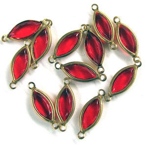 May include: Ten red glass teardrop-shaped beads with gold-toned metal loops. The beads are strung on a wire and are ready to be used in jewelry making.