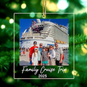 May include: Clear acrylic ornament with a family photo on a cruise ship. The photo shows a group of people posing in front of a large cruise ship. The text "Family Cruise Trip 2025" is written in white script at the bottom.