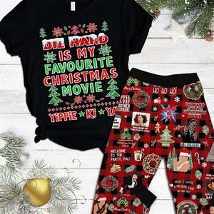 May include: Black t-shirt and pajama pants set. The shirt reads "Die Hard is my favourite Christmas movie" in white, green, and red. The pajama pants have a red and black plaid pattern with Christmas-themed graphics and text.