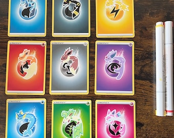 May include: Nine Pokemon trading cards featuring different Pokemon characters with the word "ENERGY" printed on each card.