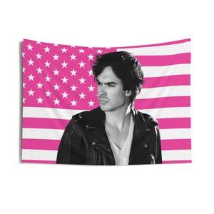 May include: A black and white tapestry featuring a man in a leather jacket against a pink and white American flag background. The tapestry is rectangular and suitable for wall decor.