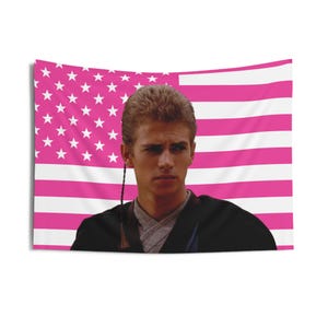 May include: A wall tapestry featuring a portrait of a man in front of a pink American flag. The flag has white stars in the upper left corner and pink and white stripes. The man is wearing a black robe and has brown hair.