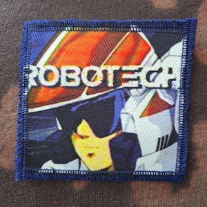 May include: A set of three ceramic mugs with a speckled, matte finish. The mugs are in shades of cream, light gray, and dark gray. Each mug has a simple, minimalist design and a rounded handle.