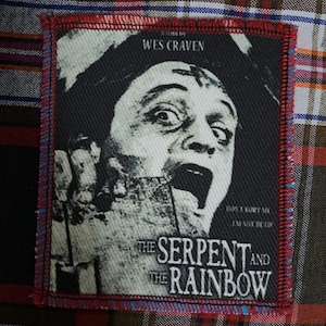 May include: A rectangular patch featuring a black and white image from the film "The Serpent and the Rainbow" by Wes Craven. The patch has a red stitched border and includes the text "Don't bury me, I'm not dead."