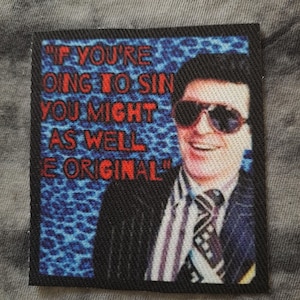 May include: A square patch with the quote "IF YOU'RE GOING TO SIN YOU MIGHT AS WELL BE ORIGINAL" in red text. The patch features a man in sunglasses, a suit, and a patterned tie against a blue leopard print background.