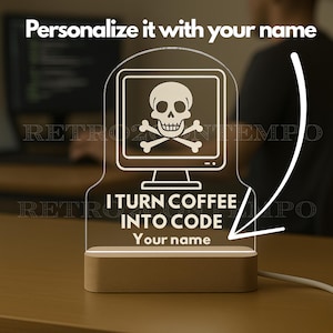 May include: A personalized desk lamp with a computer screen graphic featuring a skull and crossbones. The lamp reads "I TURN COFFEE INTO CODE" and "Your name". The base is made of wood.