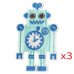 May include: Three blue robot iron-on patches with a clock face and white details.