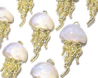 May include: A collection of iridescent white and gold jellyfish charms. The charms are made of resin and have a glittery finish. They are perfect for adding a touch of whimsy to jewelry or crafts.