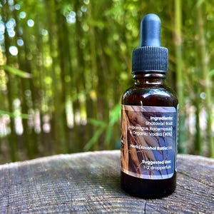 1oz Shatavari Root tincture bottle with a label featuring the rich, earthy roots of Shatavari. The image evokes the natural, grounding essence of this revered herb, highlighting its connection to wellness and vitality