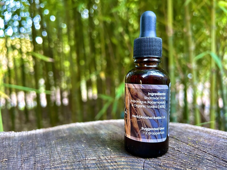 1oz Shatavari Root tincture bottle with a label featuring the rich, earthy roots of Shatavari. The image evokes the natural, grounding essence of this revered herb, highlighting its connection to wellness and vitality