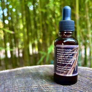 1oz Shatavari Root tincture bottle with a label featuring the rich, earthy roots of Shatavari. The image evokes the natural, grounding essence of this revered herb, highlighting its connection to wellness and vitality