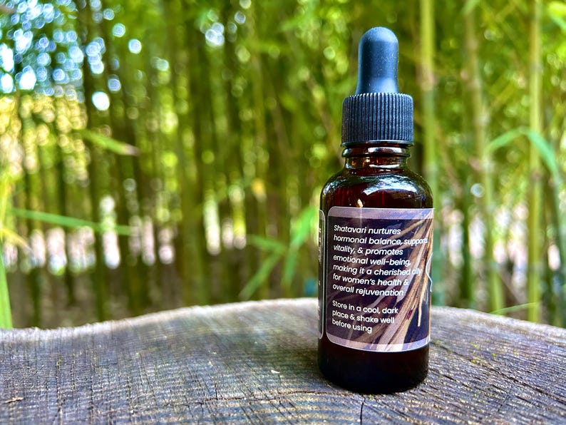 1oz Shatavari Root tincture bottle with a label featuring the rich, earthy roots of Shatavari. The image evokes the natural, grounding essence of this revered herb, highlighting its connection to wellness and vitality