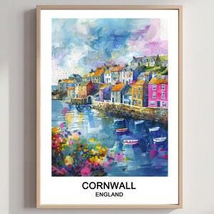 May include: Watercolor print of Cornwall, England, featuring colorful buildings along a harbor. The artwork showcases a vibrant scene with boats, flowers, and a cloudy sky. The text "CORNWALL ENGLAND" is at the bottom.